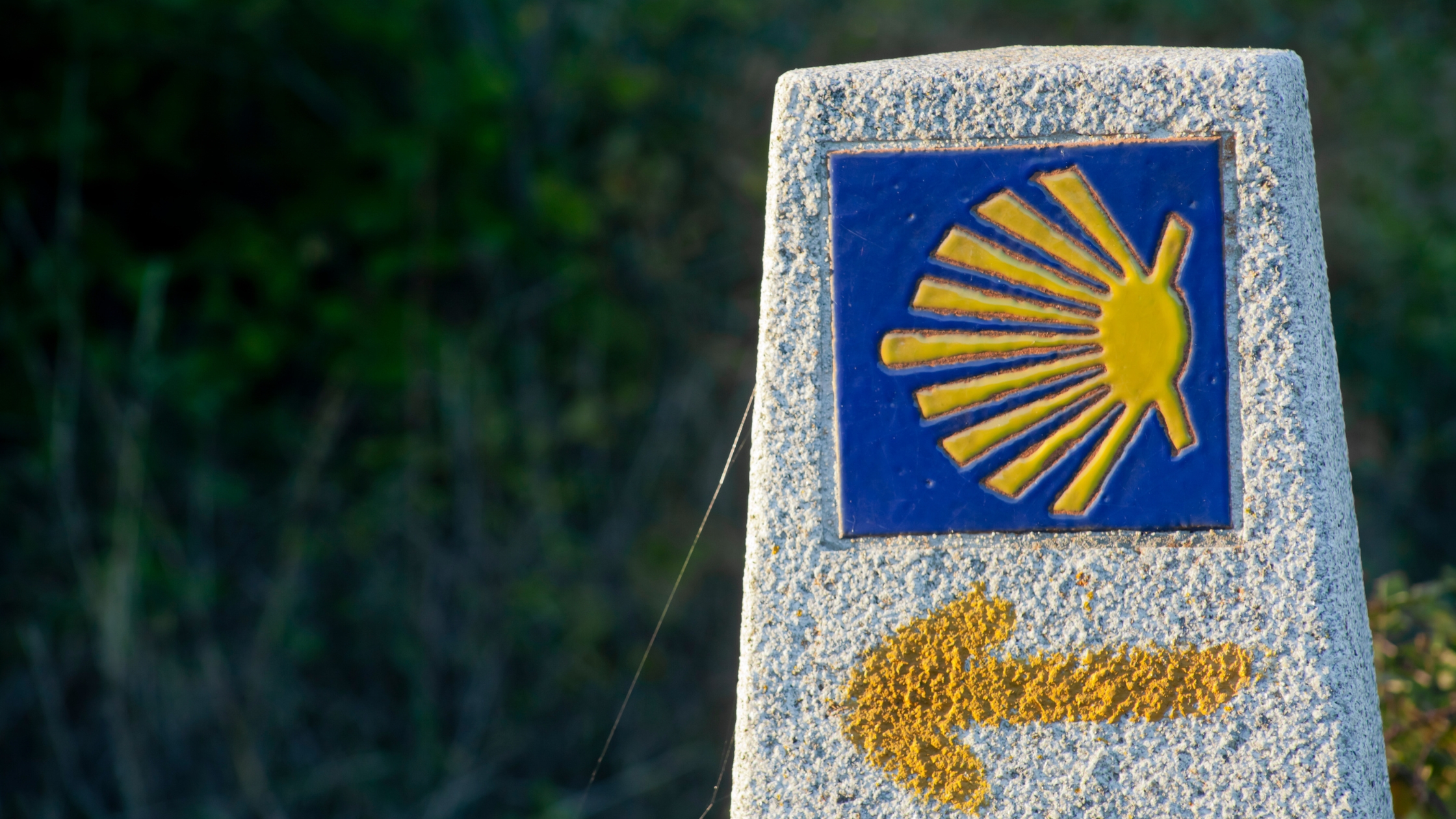 Camino waymarker stone with scallop shell symbol